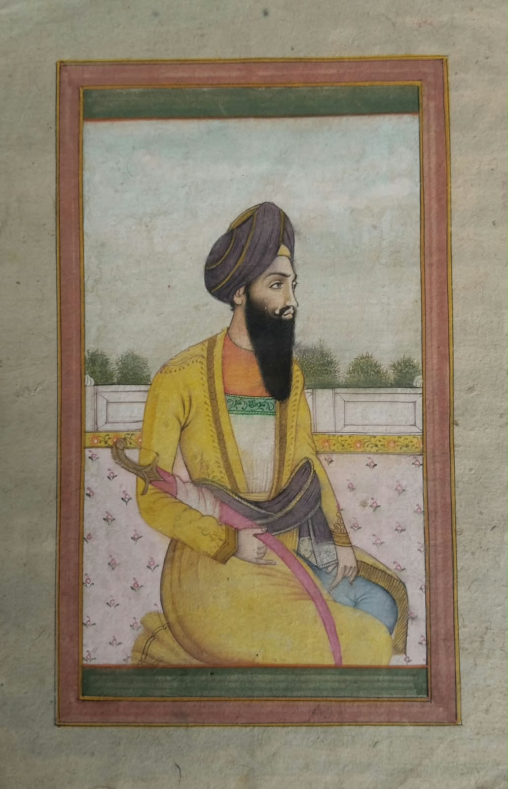 Miniature mughal painting depicting a saint with a sword